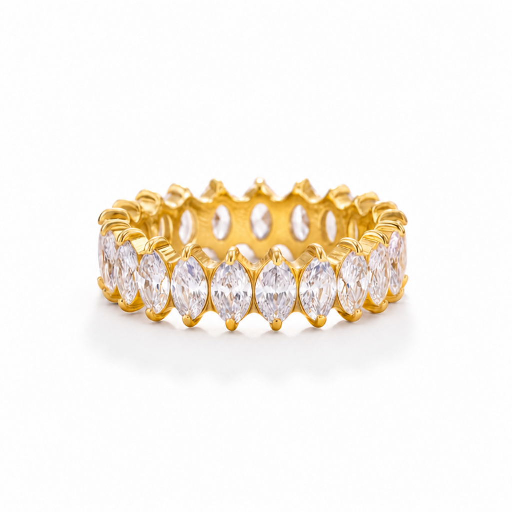A gold eternity ring featuring a continuous row of marquise-cut clear gemstones in a prong setting, shown on a clean white background.